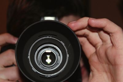 Cropped image of man holding camera