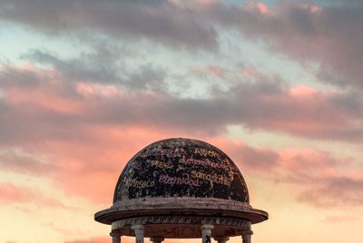 Low angle view of tower against sky at sunset