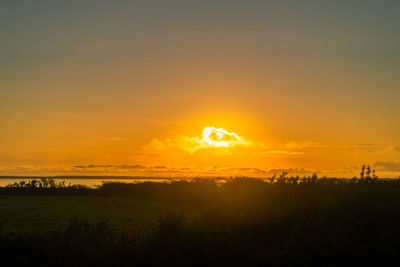 Scenic view of silhouette landscape against sky during sunset