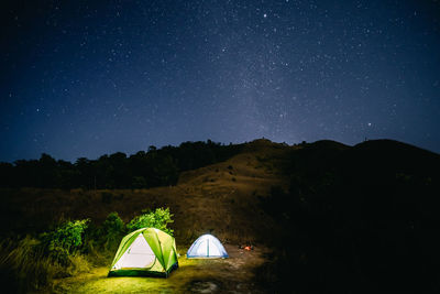 Tent on field against sky at night