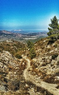 Scenic view of landscape against blue sky