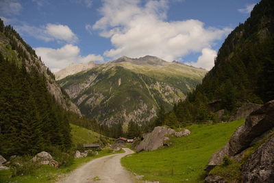 Scenic view of road amidst mountains against sky