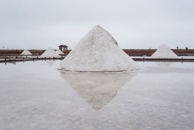 Jingzaijiao tile paved salt fields with dry salt ready for harvesting in cloudy weather in tainan city in taiwan