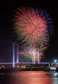 Low angle view of firework display at night