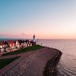 Scenic view of sea against clear sky during sunset urk lighthouse netherlands 