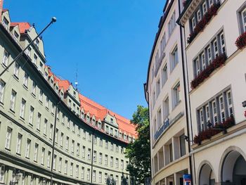 Low angle view of buildings against blue sky