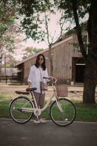 Portrait of young woman with bicycle