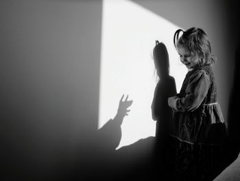 Woman in front of wall