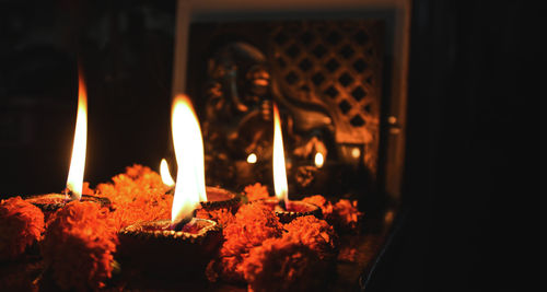 Close-up of lit candles in temple