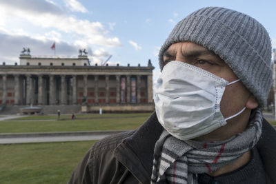 Tourism during coronavirus. man with medical mask to protect nose and mouth in front of altes museum