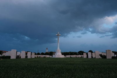 View of cemetery and buildings against sky