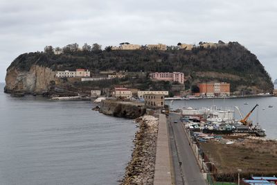 Buildings by sea against sky in city