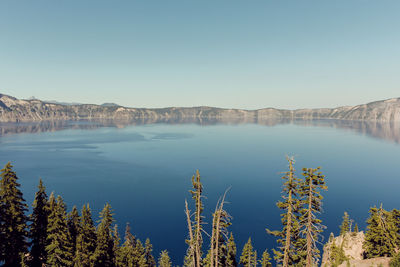 Scenic view of lake against clear blue sky