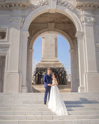Rear view of woman standing in historic building