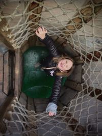 High angle portrait of girl with arms raised