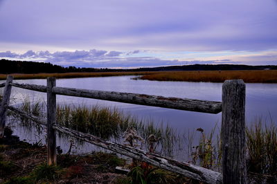 Scenic view of lake against cloudy sky