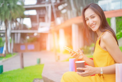 Young woman using mobile phone outdoors