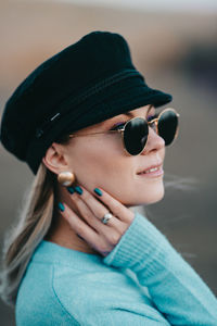 Close-up portrait of young woman wearing sunglasses