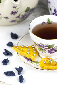 Tea cup and homemade yellow cookies