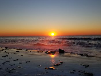 Scenic view of sea against clear sky during sunset