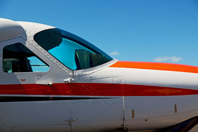 Close-up of airplane against clear blue sky