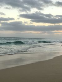 Scenic view of beach against sky during sunset