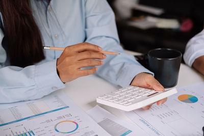 Midsection of woman working on table