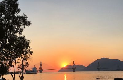 Silhouette of boats in sea during sunset