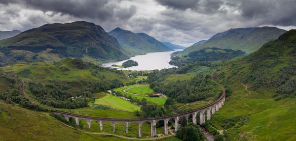 Scenic view of gkenfinnanviaduct and mountains against sky