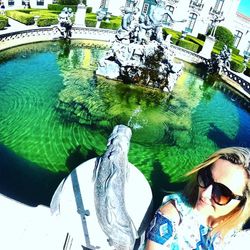 Reflection of woman in swimming pool