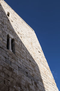 Low angle view of building against blue sky