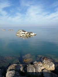 Rocks on sea shore against sky