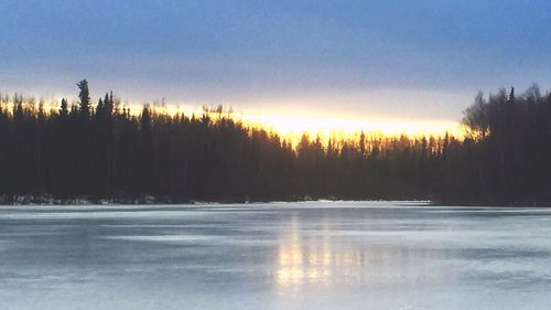 Scenic view of snow covered landscape at sunset