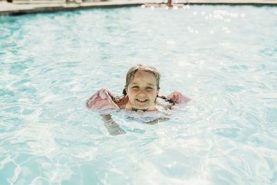 Portrait of woman swimming in pool