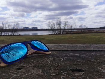 Close-up of shoes against blue sky