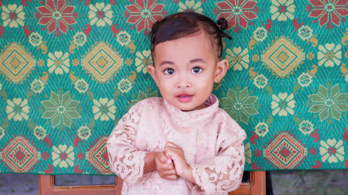 Portrait of cute baby girl at home