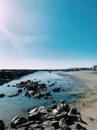 Scenic view of sea against blue sky