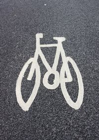 High angle view of bicycle sign on road