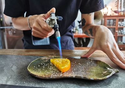 Midsection of man preparing food