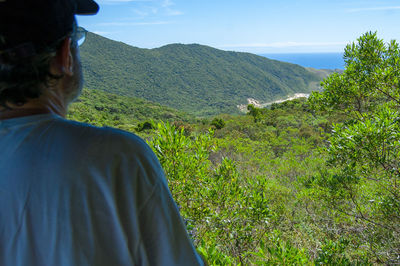 Rear view of man looking at mountains