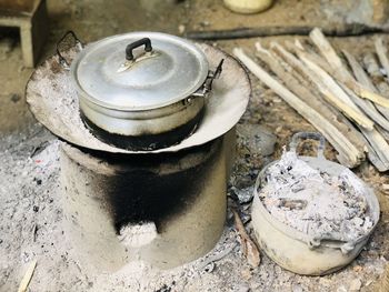 High angle view of food cooking in container over firepit