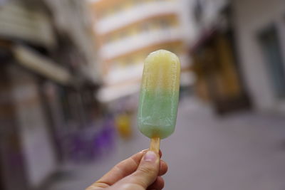 Cropped image of hand holding ice cream