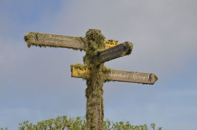 Low angle view of cross against sky