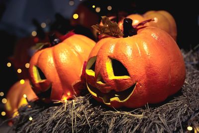 Close-up of pumpkin on illuminated during halloween
