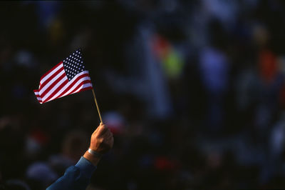 Cropped hand holding american flag