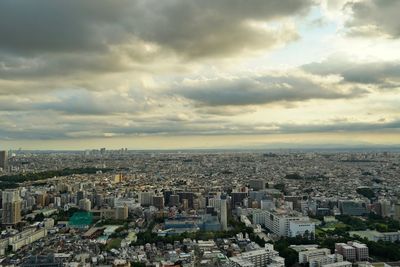 High angle view of city against cloudy sky