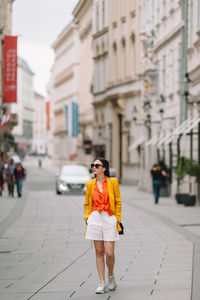 Woman standing on street in city