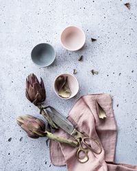 Directly above shot of cups and flowers on table