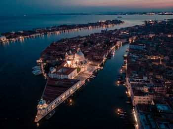 High angle view of illuminated buildings in city at night