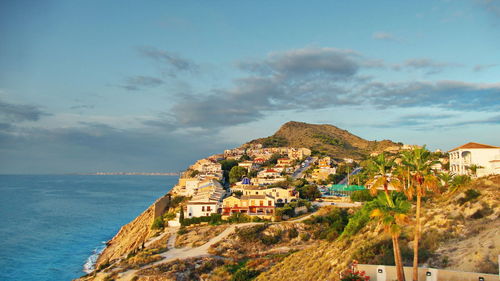 Townscape by sea against sky in town